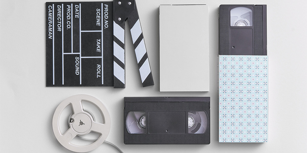 clapperboard, film tape, and vhs tapes
