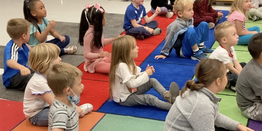 Kindergarten students participate in music class.