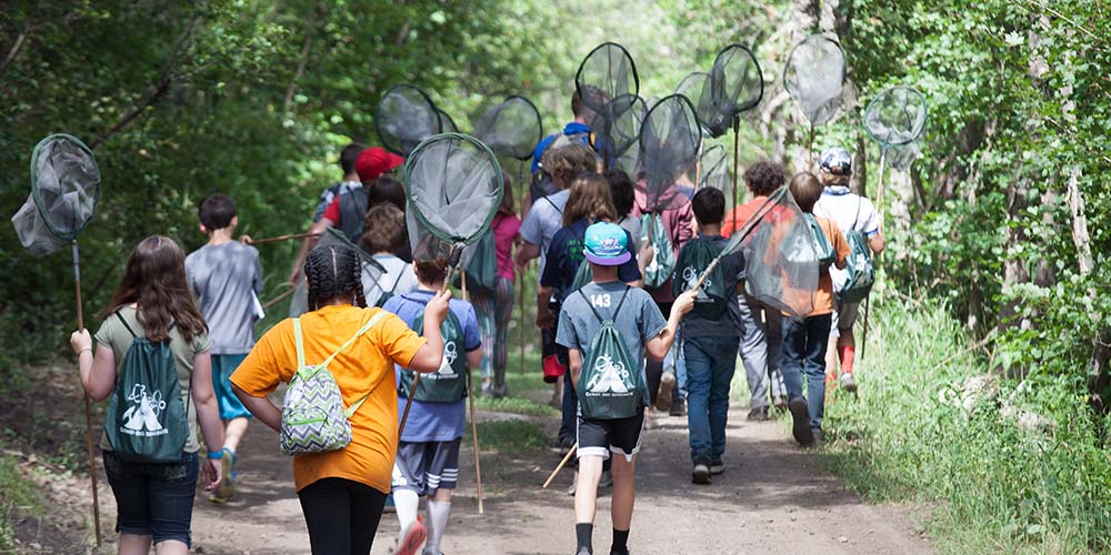 Students walking with bug nets at Camp Big Springs