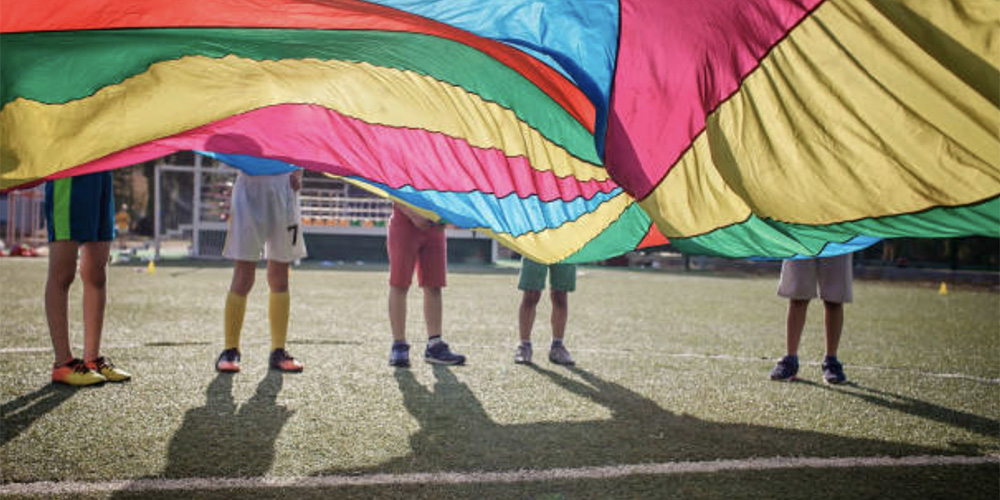 Students play with a parachute