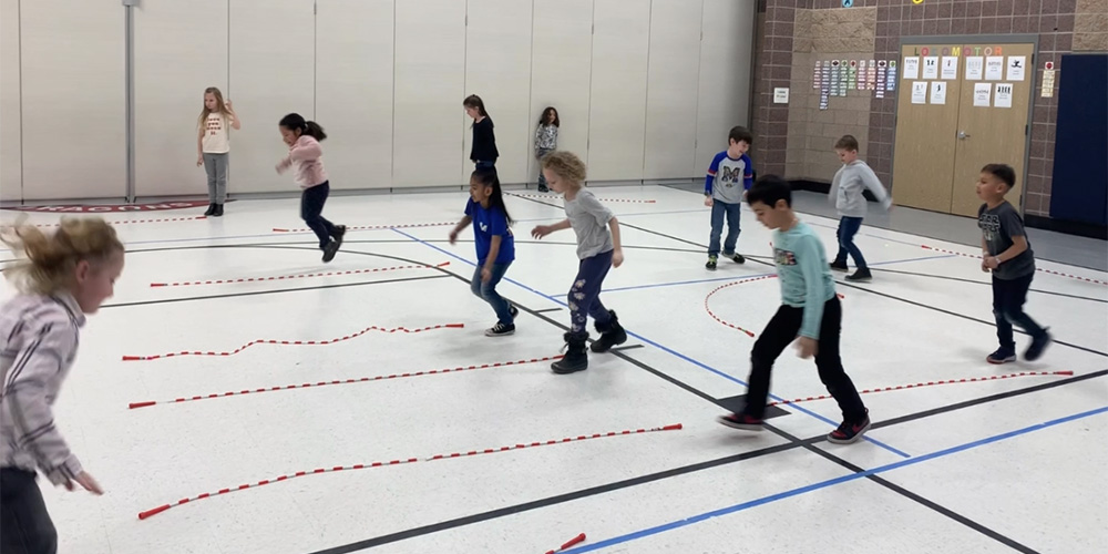 Students participate in jump rope activities in PE