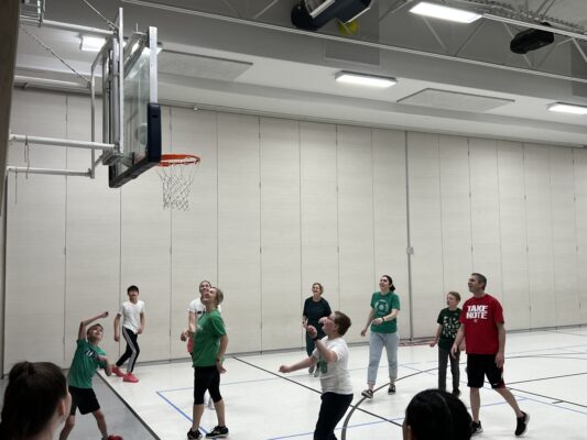 Students and teachers on the basketball court