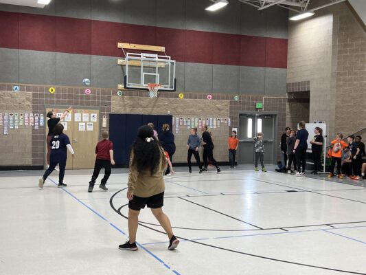 5th grade students play basketball against the teachers