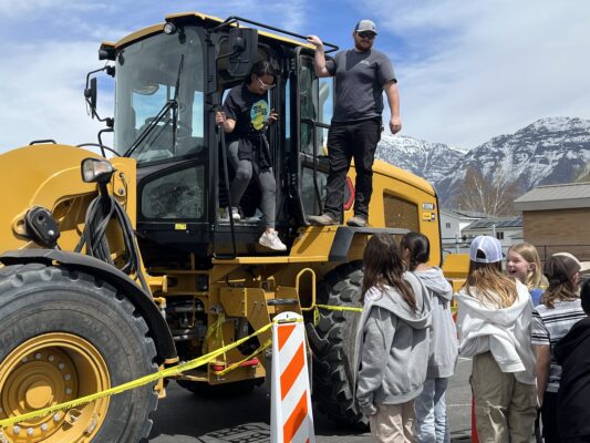 Students using machinery from Provo City Public Works