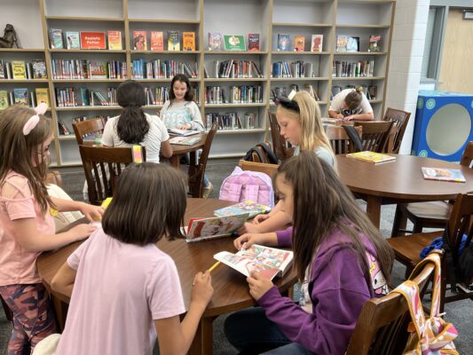 students reading books from the beehive book list